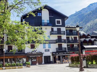 a building in a town in the mountains at Studio Le Chailloud-4 by Interhome in Chamonix-Mont-Blanc