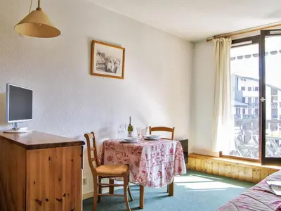a kitchen with a table with a table cloth on it at Studio Le Chailloud-4 by Interhome in Chamonix-Mont-Blanc