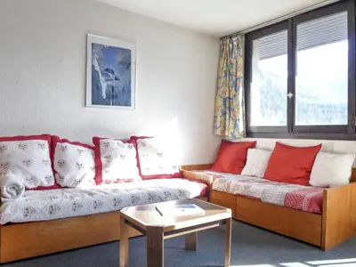 a living room with two couches and a table at Apartment Le Chamois Blanc-10 by Interhome in Chamonix-Mont-Blanc