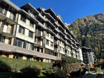 an apartment building with a mountain in the background at Apartment Le Chamois Blanc-10 by Interhome in Chamonix-Mont-Blanc