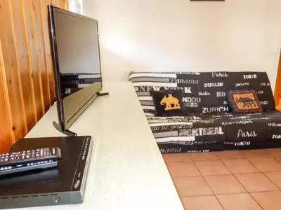 a desk with a mirror and a computer on it at Apartment Jardins Alpins 4 by Interhome in Saint-Gervais-les-Bains