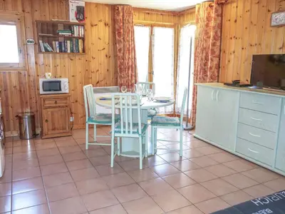 a dining room with a table and chairs and a couch at Apartment Jardins Alpins 4 by Interhome in Saint-Gervais-les-Bains