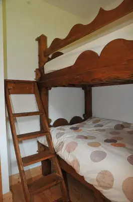 a bedroom with two bunk beds with a ladder at Residence Le Pas Au Loup in Samoëns