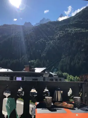 a kitchen with white cabinets and stainless steel appliances at Aiguille du Midi - Le Chamo'nid in Chamonix-Mont-Blanc