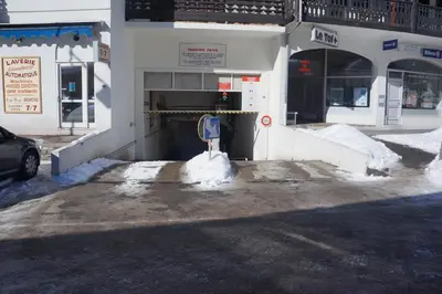 a parking meter in the snow in front of a building at Aiguille du Midi - Le Chamo'nid in Chamonix-Mont-Blanc