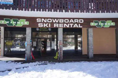 a snowboard ski rental sign in front of a building at Aiguille du Midi - Le Chamo'nid in Chamonix-Mont-Blanc