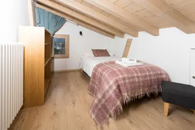 a bedroom with a bed with a blanket on it at Chalet De L'ours - Chamonix All Year in Chamonix-Mont-Blanc