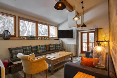 a living room with a couch and a table at Loft Apartment High Rimaye - Mont Blanc Views, Close to Brevent in Chamonix-Mont-Blanc