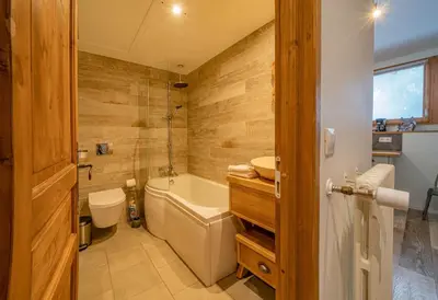 a bathroom with a tub and a toilet and a sink at Loft Apartment High Rimaye - Mont Blanc Views, Close to Brevent in Chamonix-Mont-Blanc