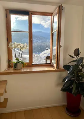a window with a view of a mountain at Chalet à Megève-Vauvray - Grands Appartements , vue Mont Blanc in Demi-Quartier