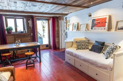 a living room with a couch and a desk at Chalet à Megève-Vauvray - Grands Appartements , vue Mont Blanc in Demi-Quartier