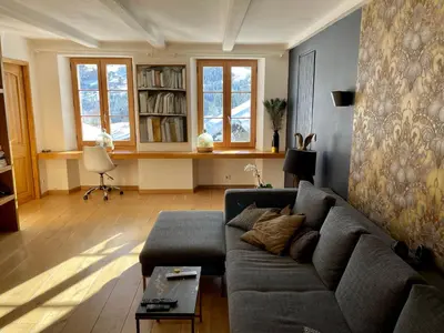 a living room with a couch and a table at Chalet à Megève-Vauvray - Grands Appartements , vue Mont Blanc in Demi-Quartier