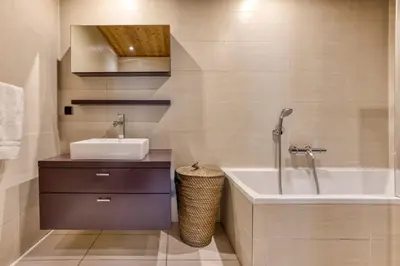 a bathroom with a sink and a bath tub at Apartment Au Bon Coin - Luxury Chamonix Hidden Haven, Mont Blanc view, Hot Tub and Garden in Chamonix-Mont-Blanc