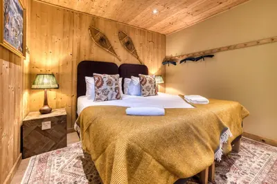 a bedroom with a large bed in a room at Apartment Au Bon Coin - Luxury Chamonix Hidden Haven, Mont Blanc view, Hot Tub and Garden in Chamonix-Mont-Blanc