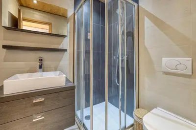 a bathroom with a shower and a sink at Apartment Au Bon Coin - Luxury Chamonix Hidden Haven, Mont Blanc view, Hot Tub and Garden in Chamonix-Mont-Blanc