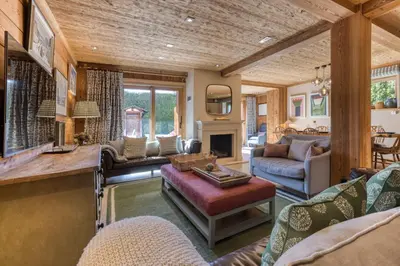 a living room filled with furniture and a fireplace at Apartment Au Bon Coin - Luxury Chamonix Hidden Haven, Mont Blanc view, Hot Tub and Garden in Chamonix-Mont-Blanc