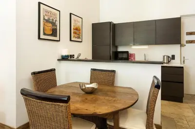 a dining room with a wooden table and chairs at Apartment Majestic 1 - Central Chamonix Haven Mont Blanc in Chamonix-Mont-Blanc