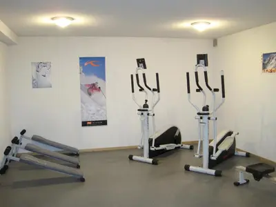 a gym with several cardio machines in a room at Lagrange Vacances Les Arolles in Saint-Gervais-les-Bains