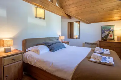 a bedroom with a bed with two towels on it at Villa Vallet Apartment - Chamonix All Year in Chamonix-Mont-Blanc