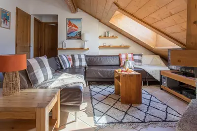 a living room with a couch and a table at Villa Vallet Apartment - Chamonix All Year in Chamonix-Mont-Blanc