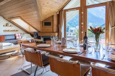 a dining room with a large wooden table and chairs at Villa Vallet Apartment - Chamonix All Year in Chamonix-Mont-Blanc