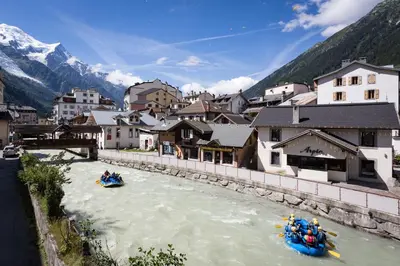 a group of people rafting down a river in a town at Mont Blanc 212 Apartment - Chamonix All Year in Chamonix-Mont-Blanc