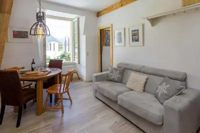 a living room with a couch and a table at Mont Blanc 212 Apartment - Chamonix All Year in Chamonix-Mont-Blanc