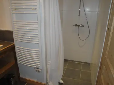 a shower with a white shower curtain in a bathroom at megeve appartement des Crêtets in Megève