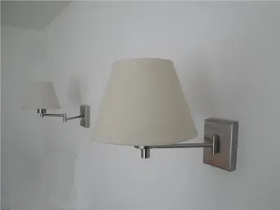 two lights are attached to a white wall at megeve appartement des Crêtets in Megève