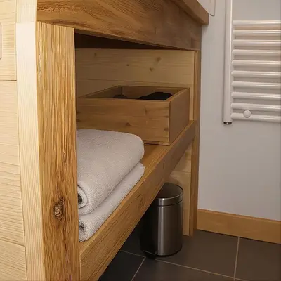 a wooden cabinet with towels in a room at megeve appartement des Crêtets in Megève
