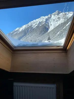 a skylight in a room with a snow covered mountain at Appartement Les Arolles in Chamonix-Mont-Blanc