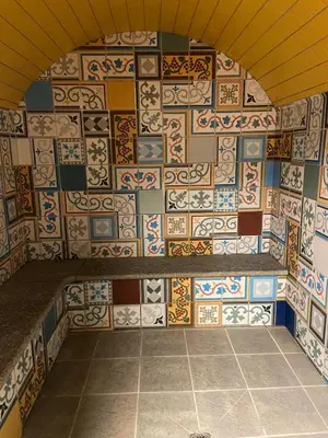 a room with a wall covered in colorful tiles at Appartement Les Arolles in Chamonix-Mont-Blanc