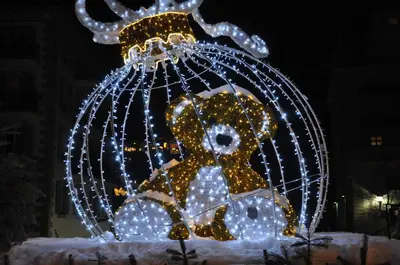 a teddy bear in a cage with lights at Appartement Les Arolles in Chamonix-Mont-Blanc