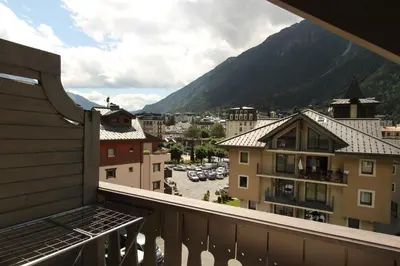 a balcony with a view of a city and a mountain at Appartement Les Arolles in Chamonix-Mont-Blanc