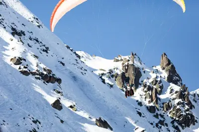 a person flying a parachute over a snow covered mountain at La Belle Epoque - Chamonix All Year in Chamonix-Mont-Blanc