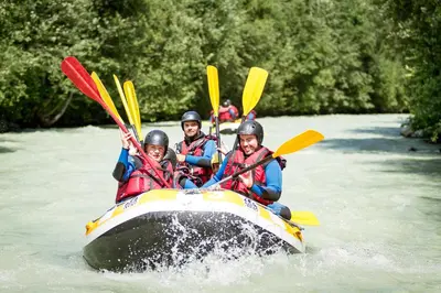a group of people in a raft on a river at La Belle Epoque - Chamonix All Year in Chamonix-Mont-Blanc