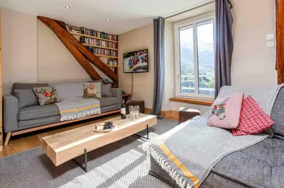 a living room with a couch and a table at La Belle Epoque - Chamonix All Year in Chamonix-Mont-Blanc