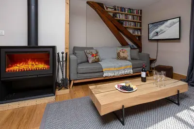 a living room with a couch and a fireplace at La Belle Epoque - Chamonix All Year in Chamonix-Mont-Blanc