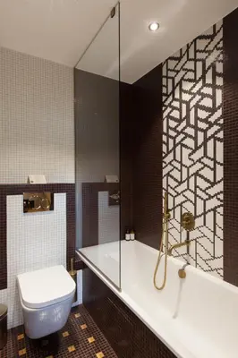 a bathroom with a tub and a toilet and a sink at Au Coin Du Feu in Megève