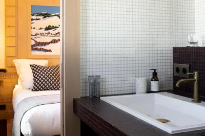 a bathroom with a large white tub in a room at Au Coin Du Feu in Megève