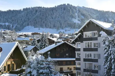 a building with icicles hanging from it in the snow at Au Coin Du Feu in Megève