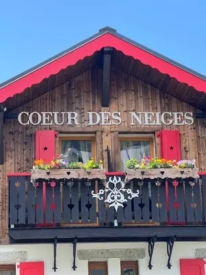 a sign on the front of a wooden building at Coeur des Neiges in Saint-Gervais-les-Bains