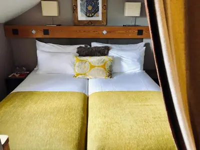 a bed with a teddy bear sitting on top of it at Coeur des Neiges in Saint-Gervais-les-Bains