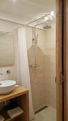a bathroom with a sink and a shower at Hotel Du Clocher in Chamonix-Mont-Blanc