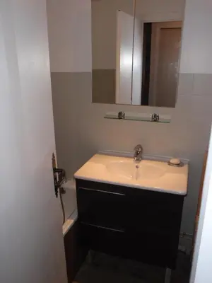 a bathroom with a sink and a mirror at Hôtel Rent in Megève
