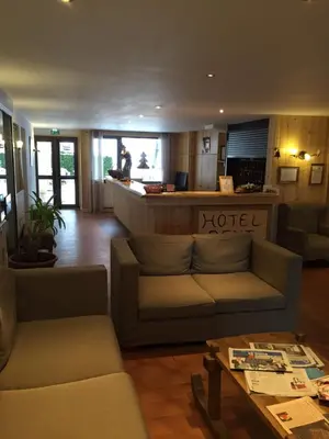 a living room with a couch and a table at Hôtel Rent in Megève