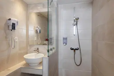 a bathroom with a sink and a shower at Le Saint Antoine in Les Houches