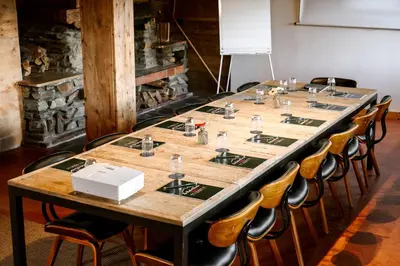 a long table in a room with chairs at Hôtel Les Roches Fleuries in Cordon