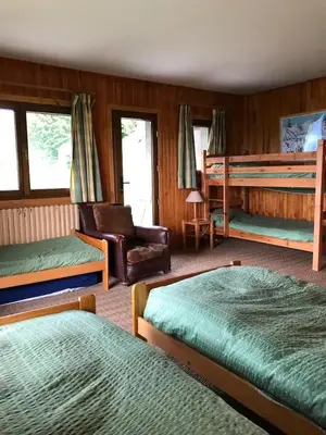 a bedroom with two beds and a couch and a chair at Chalet spacieux à Cordon 180 m² avec vue montagne in Cordon