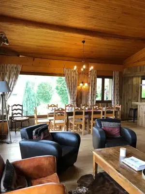 a man laying on a couch in a living room at Chalet spacieux à Cordon 180 m² avec vue montagne in Cordon